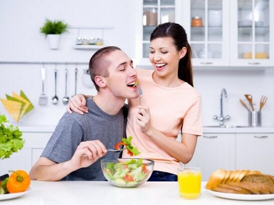 a woman feeds a man with a product to increase potency naturally