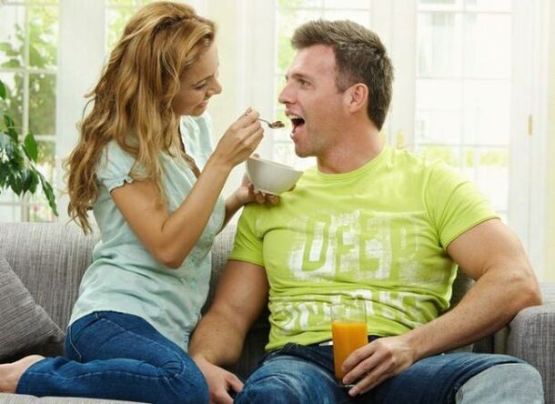 a woman feeds a man with a product to increase potency